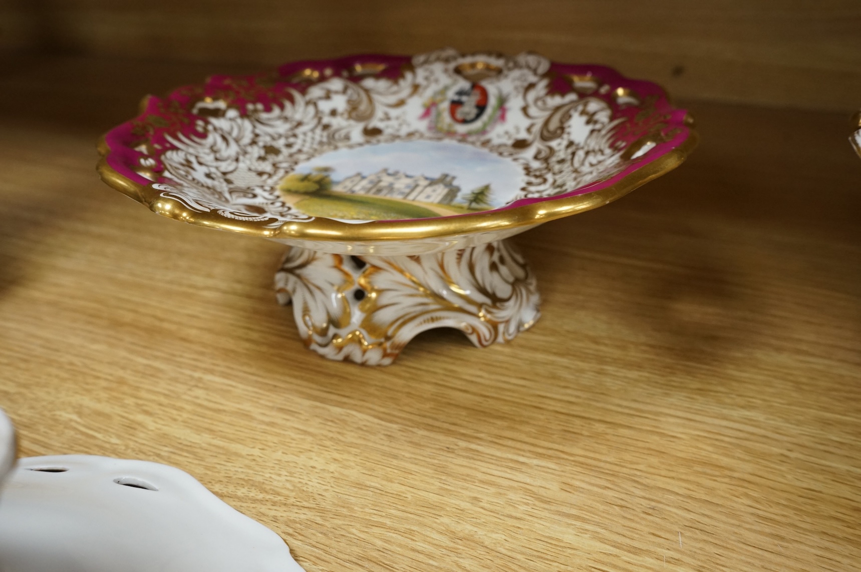 Four G Grainger, Worcester armorial porcelain comports, c.1845, hand painted with named views of Worcester, 24cm in diameter
